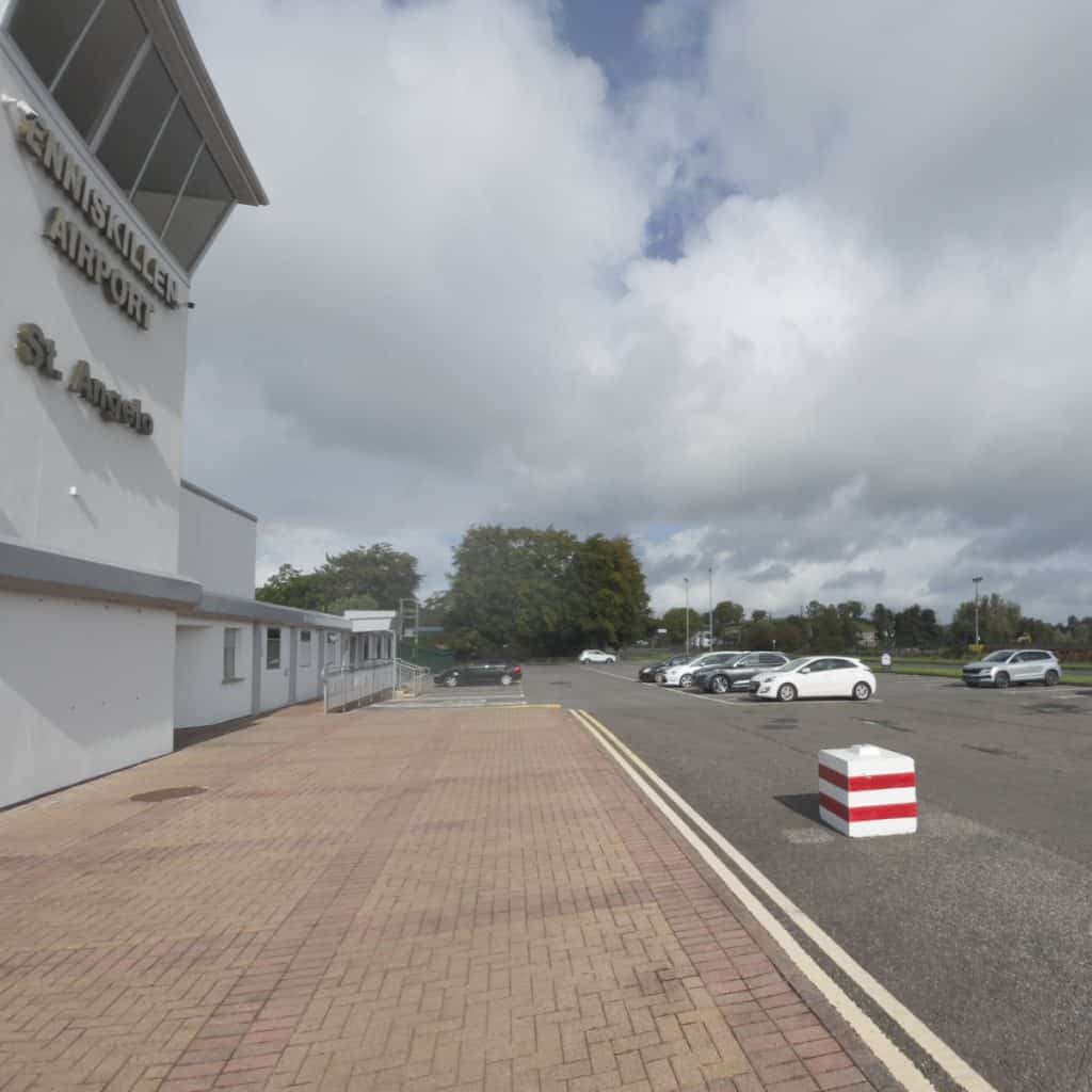 Front view of Enniskillen airport and diner showing extensive parking area.
