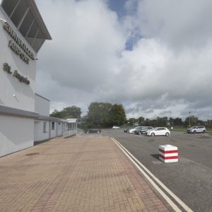 Front view of Enniskillen airport and diner showing extensive parking area.